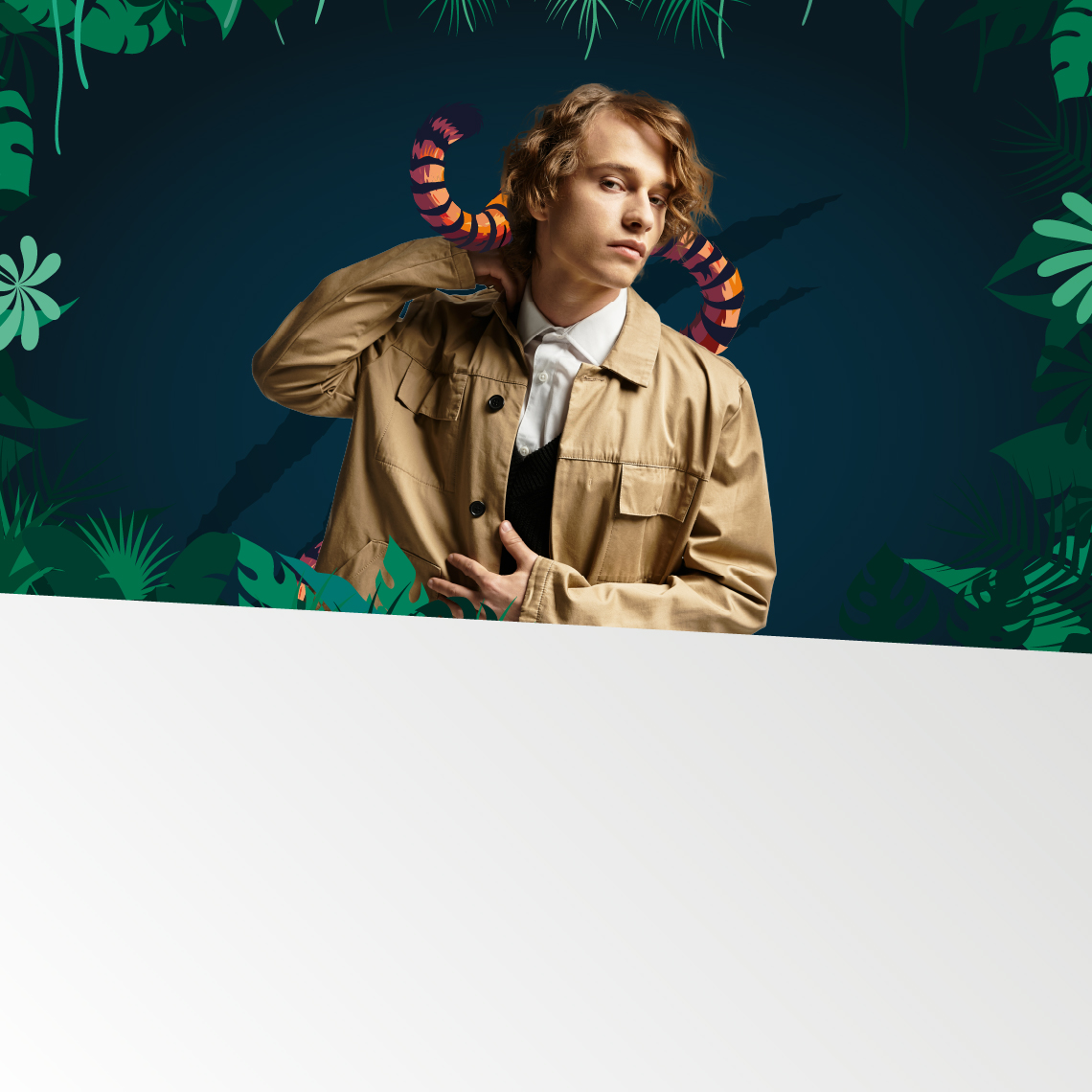 a man among the leaves, with a tiger's tail in the background